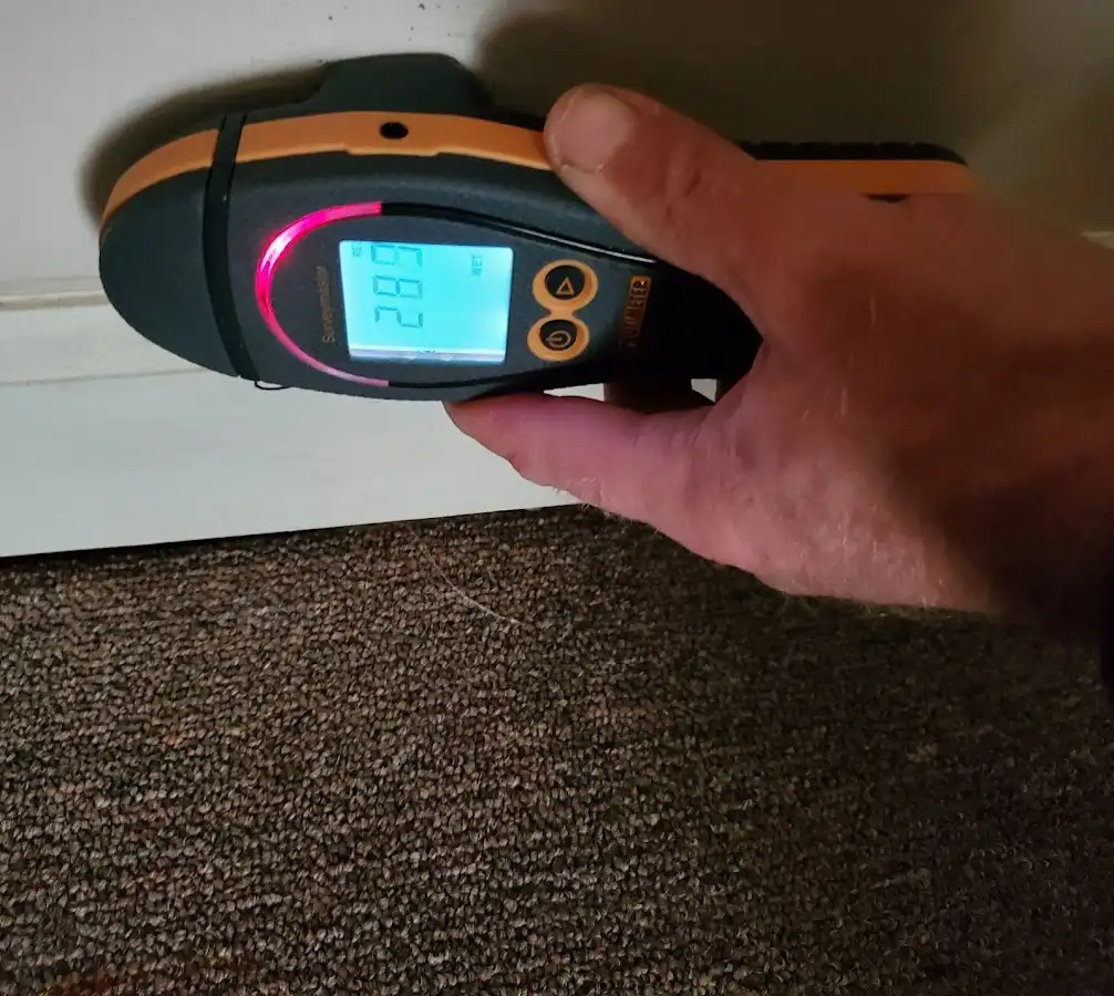 Moisture detection at baseboard during Storm Damage Restoration in LaGrange